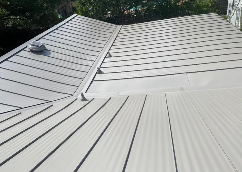 Solar attic fan installed on a metal roof for Roof Ventilation in Turner